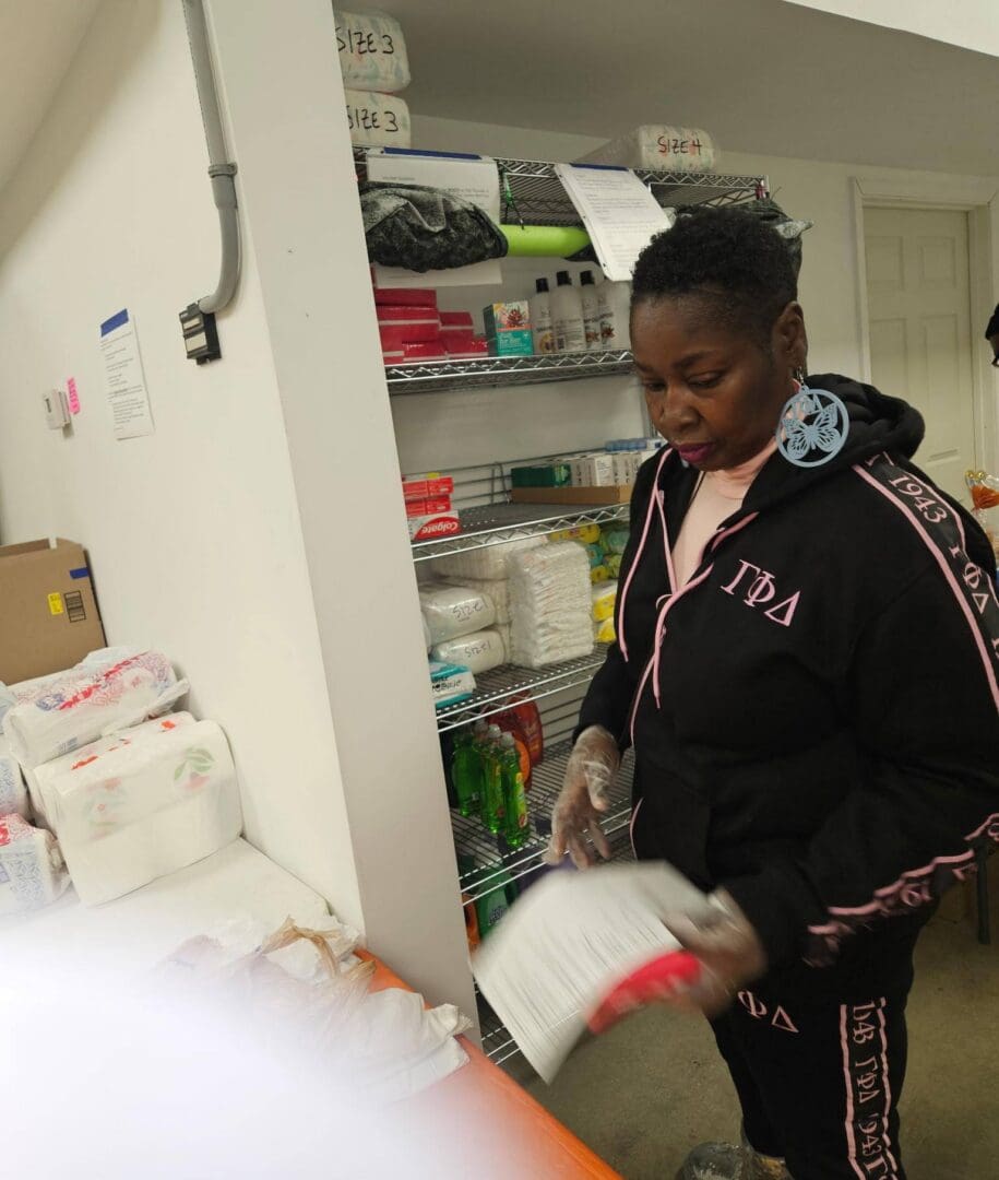 Person organizing pantry shelves with supplies